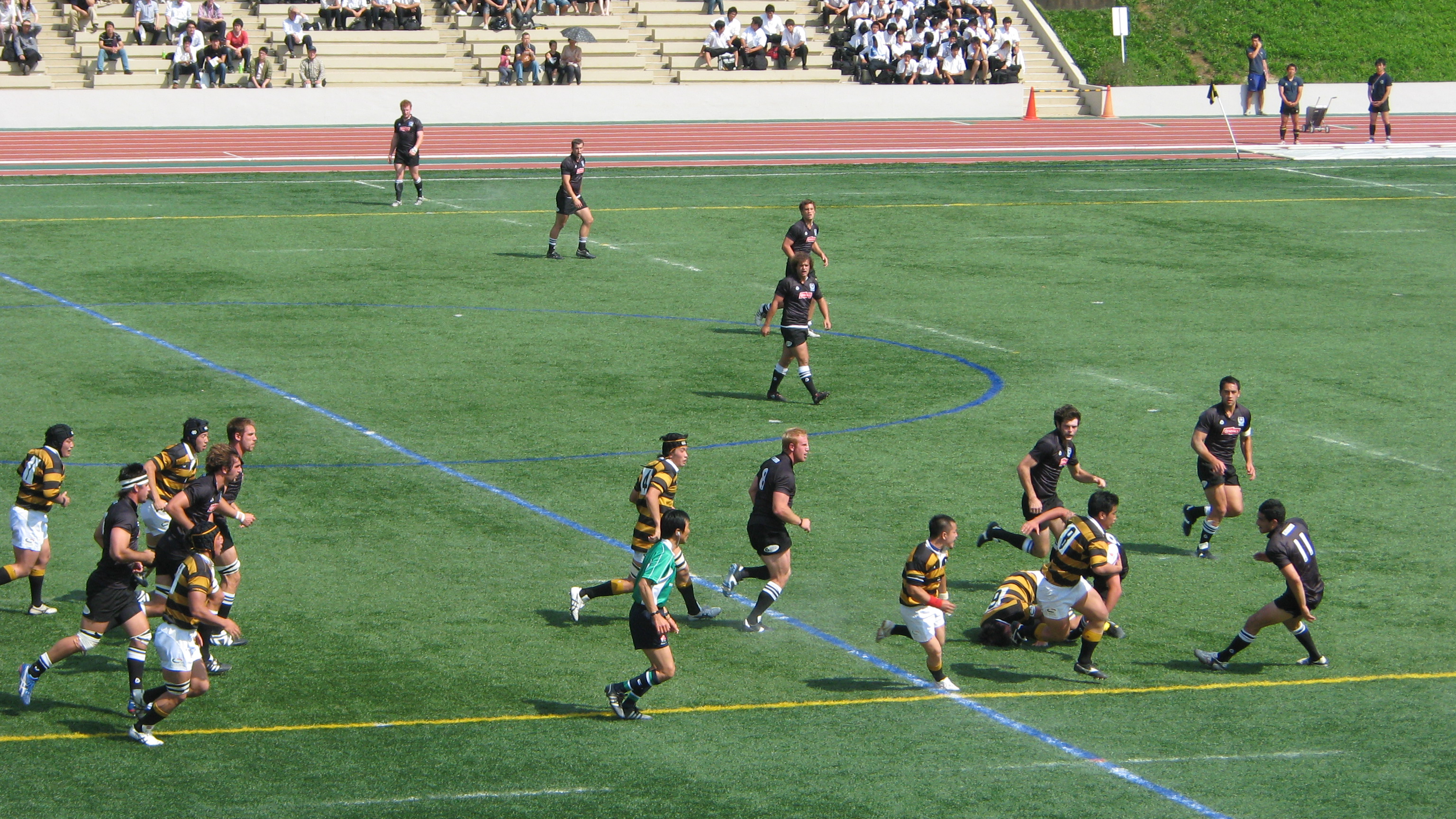 ラグビーの試合が行われている人工芝グラウンドの様子