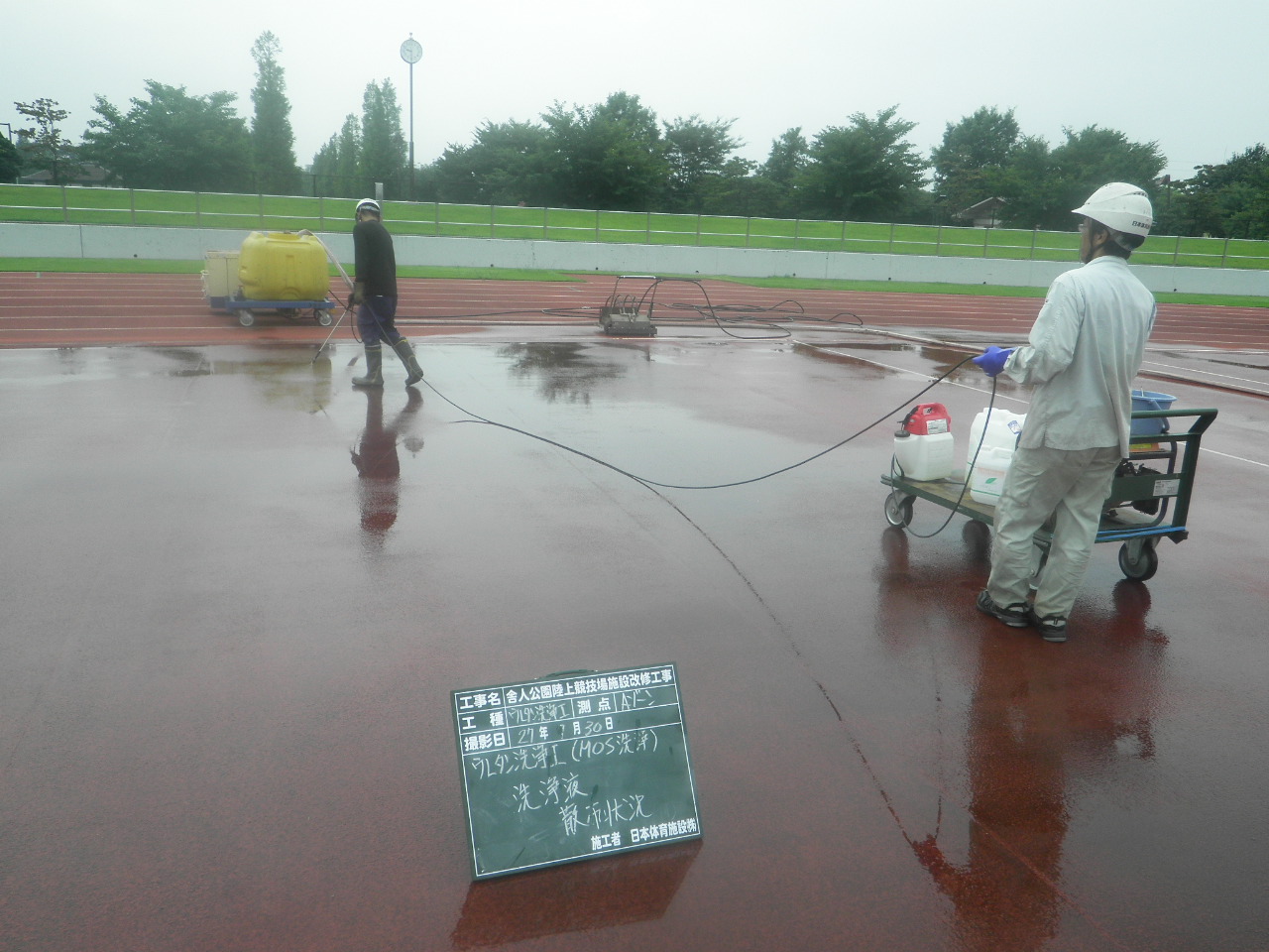 MOS洗浄工法で陸上トラックに洗浄剤を散布する作業